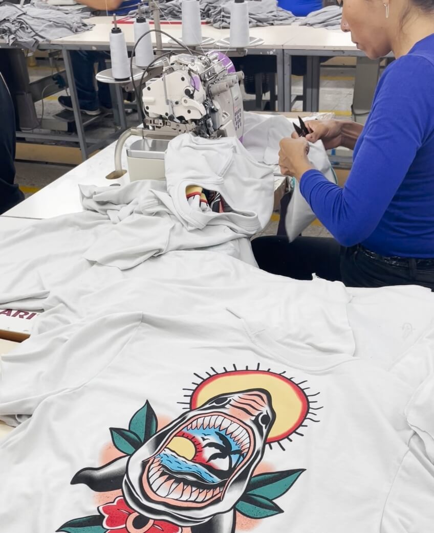 white t-shirt with a print being made by a seamstress 